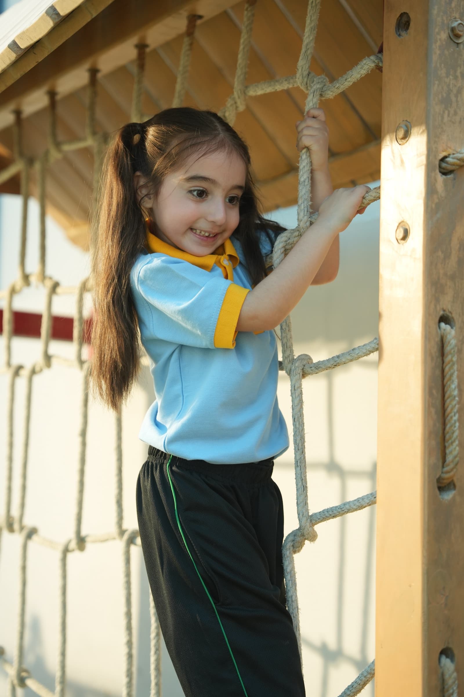 A child climbing the outdoor rope structure