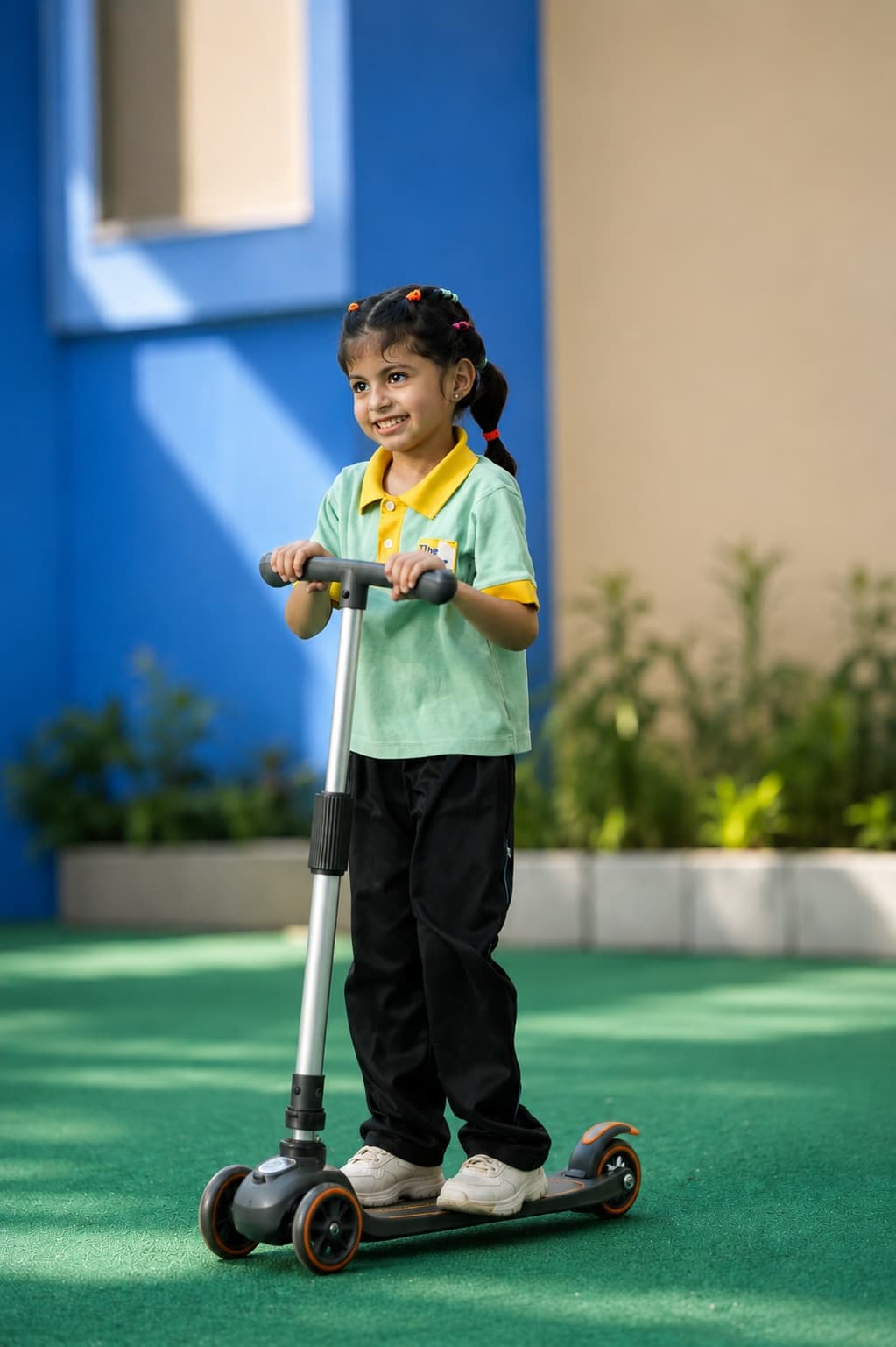 A child enjoying a ride on a scooter in the outdoor play area